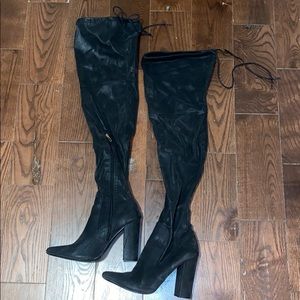 Thigh high heeled black boots